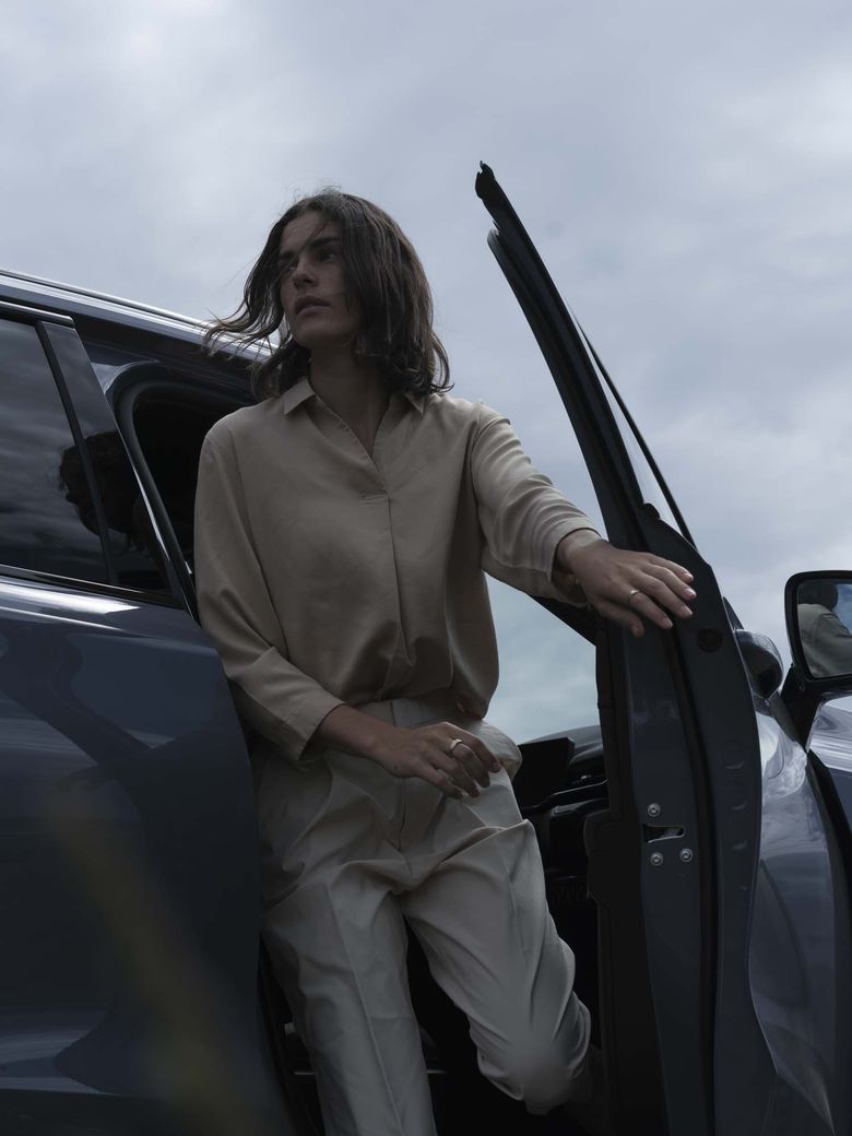 Female model exiting an Ayers Grey Haval H6 from the driver's door