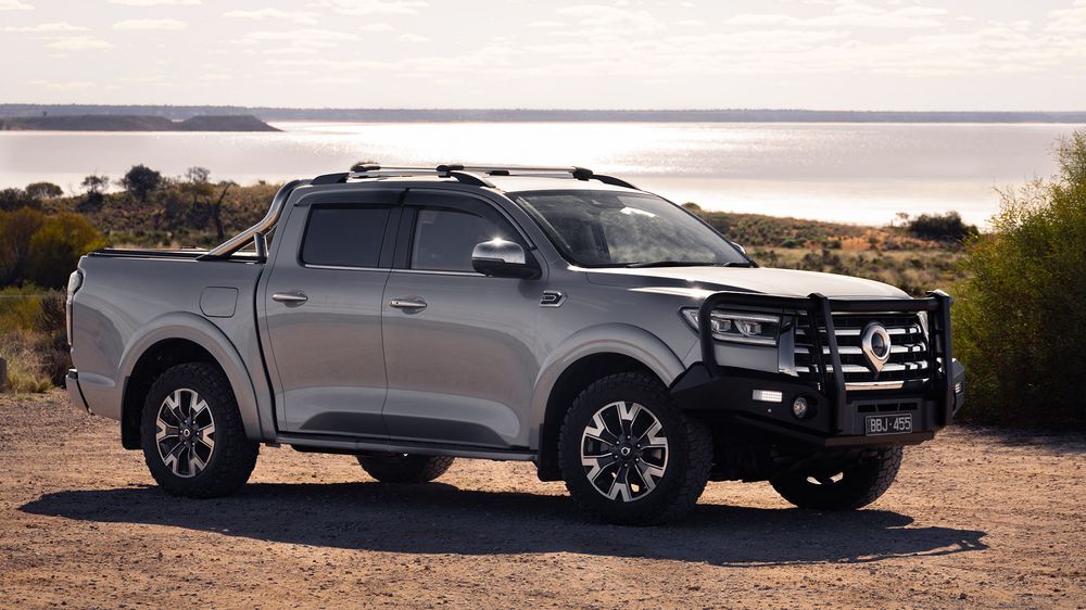 Slate Grey GWM Ute Cannon with a black bullbar parked on the gravel with the ocean in the background