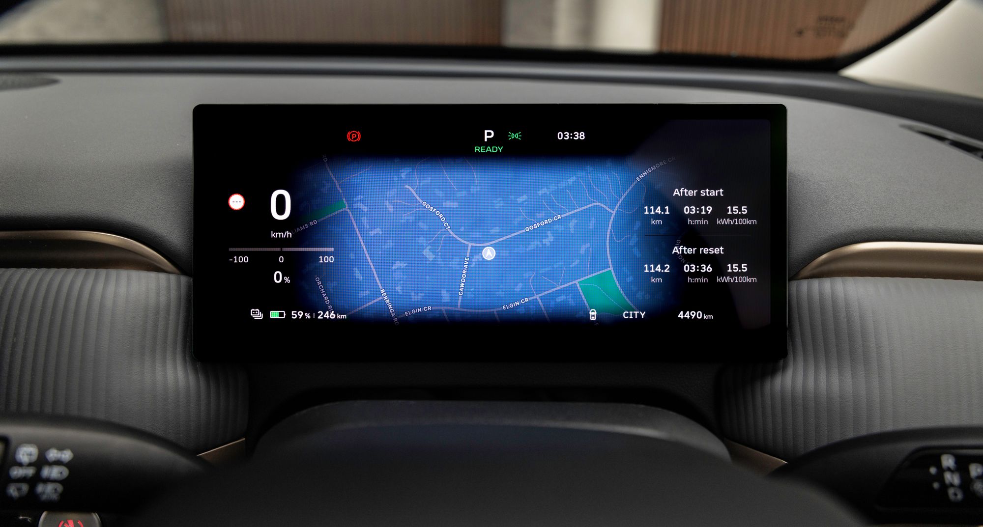 Car dashboard screen displaying GPS map, speedometer, and battery level. Speed at 0 km/h; battery at 59% with 246 km range remaining.