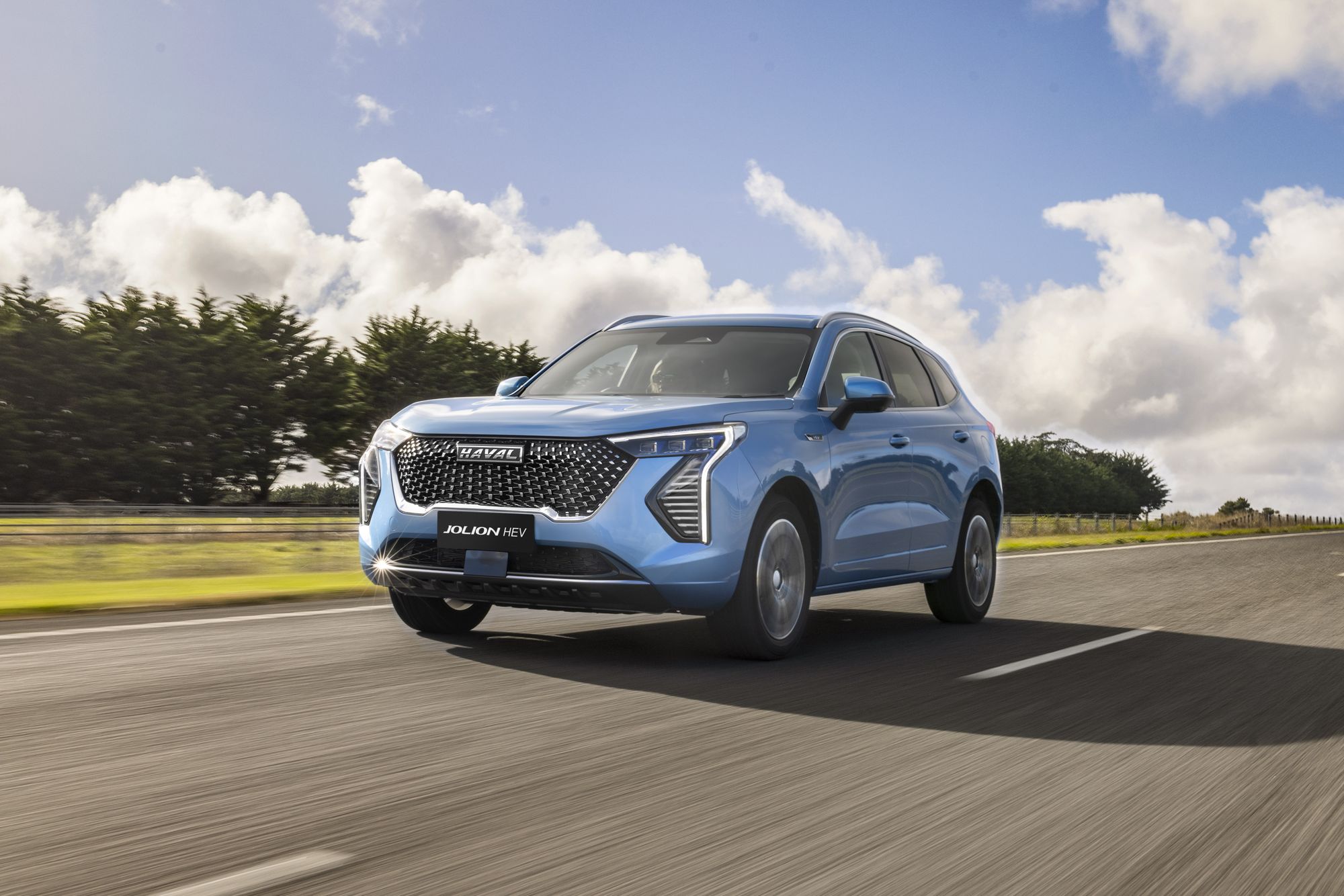 Azure Blue GWM Haval Jolion Hybrid driving through the country side
