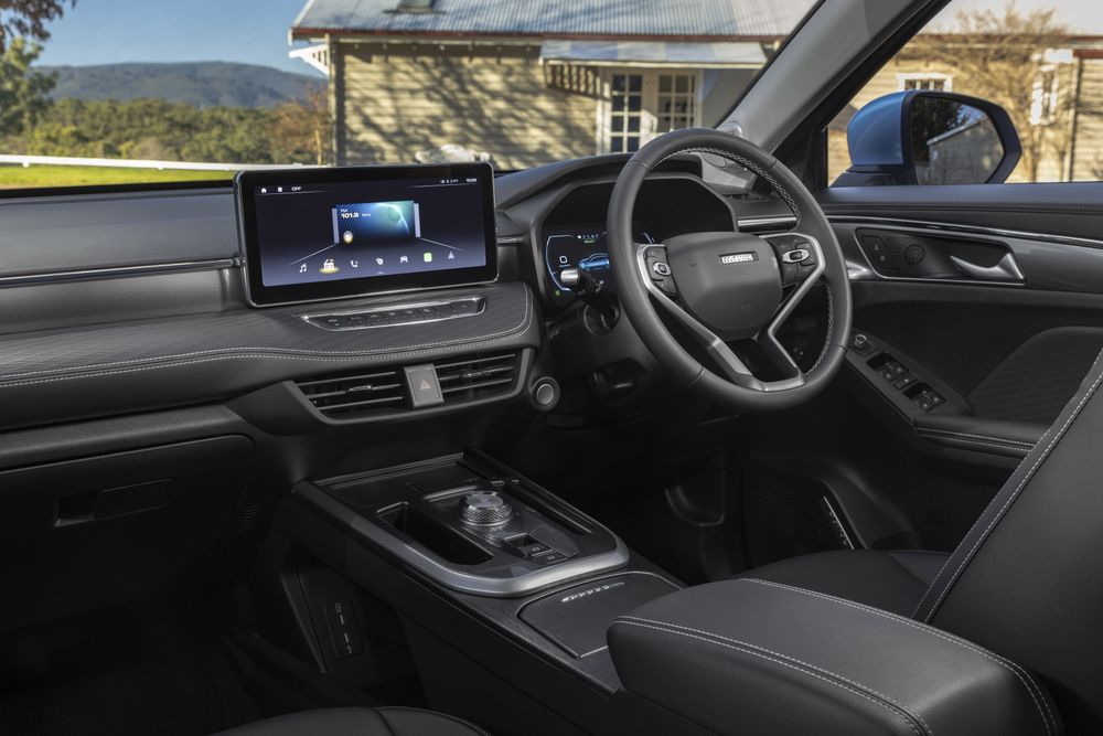 The dash of the GWM Haval Jolion Hybrid wth a country house backdrop