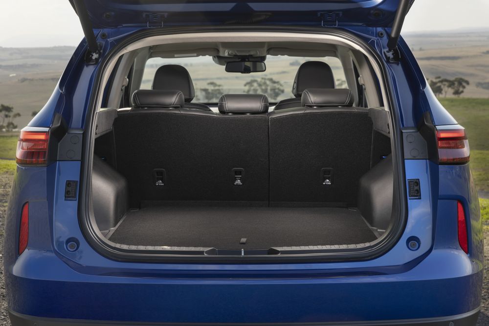 A Sapphire Blue GWM Haval H6 Hybrid with the boot open revelaing the back row seats