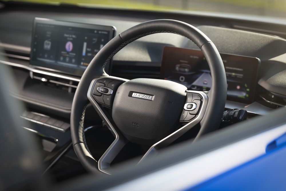The front steering wheel in a Sapphire Blue GWM Haval H6 Hybrid