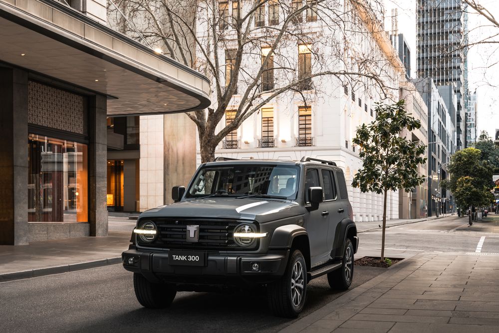 Fossil Grey GWM Tank 300 parked in the city with a french provincial style building in the background