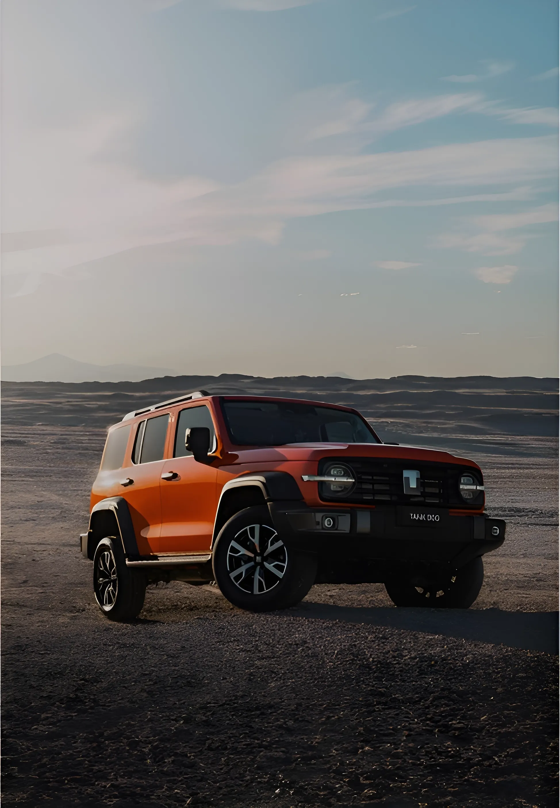 Dusk Orange Tank 300 parked on a small gravel dune with rolling hills in the background
